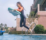 This is showing the green Asiwo Mako Electric Kickboard being held by a child jumping onto the pool.